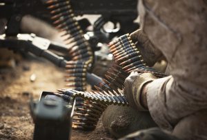 Lance Cpl. Jeremy Coltharp, a machine gunner with India Company, 3rd Battalion, 3rd Marine Regiment, holds links of ammunition for Lance Cpl. Andrew Ellis to fire during a company attack at Range 400 on Marine Corps Air Ground Combat Center Twentynine Palms, Calif., Sept. 10, 2011. The attack was part of the 35-day Enhanced Mojave Viper training exercise here. During EMV, "America's Battalion" is working from squad-level training evolutions to battalion-level counterinsurgency operations. They are training to deploy to Afghanistan's Helmand province this fall in support of Operation Enduring Freedom. Coltharp, 21, is from Fort Gibson, Okla. Ellis, 19, is from Dothan, Ala.